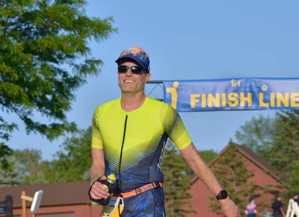 man crossing finish line